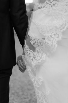 the bride and groom hold hands as they walk