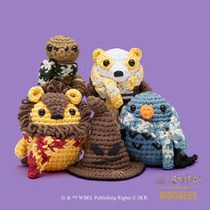 four crocheted stuffed animals sitting next to each other in front of a purple background