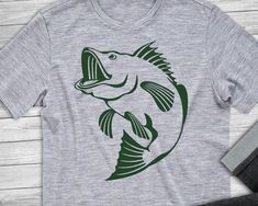 a t - shirt with a fish on the front and green print on the back