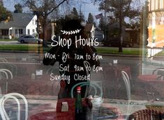 there is a sign in the window that says, shop hours monday, friday, friday, and saturday