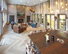 a living room filled with furniture and a fire place in the middle of an open floor plan