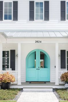 a blue front door on a white house