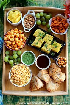 a wooden tray topped with different types of food