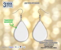 a pair of white tear shaped earrings hanging from hooks on a gold boke background