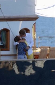 two people embracing each other on a boat