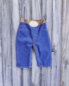 Western Cowboy Cowgirl Denim Jeans  With Belt Buckle for Baby, Toddler, Unisex Belts are cute on kids but TOTALLY impractical! Buckles are hard, uncomfortable and hurt their little tummies! The look of the belt without all the pain and hassle! Most people can't tell it's not a real buckle until they touch it. Some never figure it out!  Double washing process makes the 10 oz. denim super soft but extremely durable at the same time.  Snaps in the legs for diaper changes and tons of elastic in the waist, for the chubby and the skinny ones alike!  10 oz denim - pre-washed - pre-shrunk,  Snaps along inseam. Built in soft fabric belt and buckle.  100% Cotton.  Two real back pockets. See images for size chart with measurements. IMPORTANT: TO MAKE SURE YOU ORDER THE CORRECT SIZE WE SUGGEST YOU MEA Jeans With Belt, Cowboy Cowgirl, Jeans Kids, Cowboy And Cowgirl, Fabric Belt, Pair Of Pants, Figure It Out, Western Cowboy, Belt Buckle