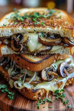 a grilled cheese and mushroom sandwich on a cutting board