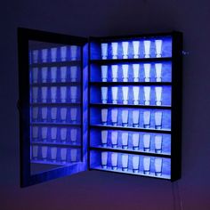 a lighted display case filled with lots of cups