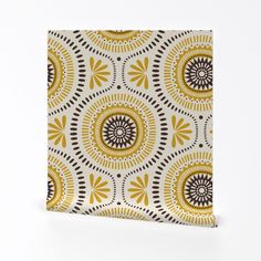 a yellow and brown pattern on a white background is featured in this square tile design