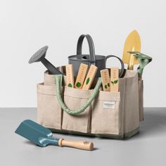 a garden tool bag with gardening utensils in it