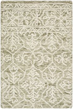 a rug with an intricate design on the front and back side, in grey and white