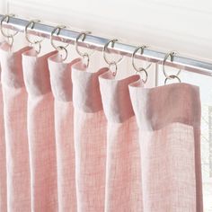 pink curtains hanging in front of a window