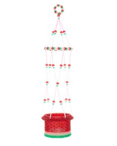 a red bucket with beads hanging from it's side and a string attached to the top