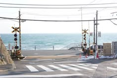 an intersection near the ocean with traffic lights