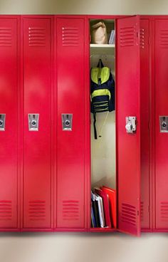 three red lockers with books and backpacks in them