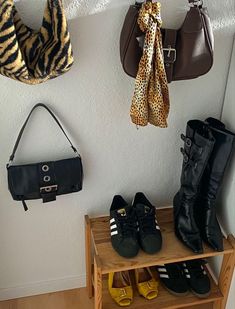 shoes and purses are hanging on the wall next to a shelf with handbags