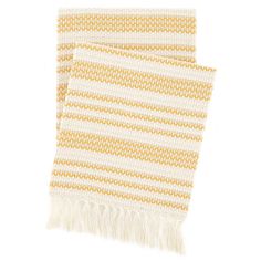 two yellow and white towels with fringes on them, one is folded up to the side