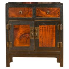 an old wooden cabinet with two doors and knobs