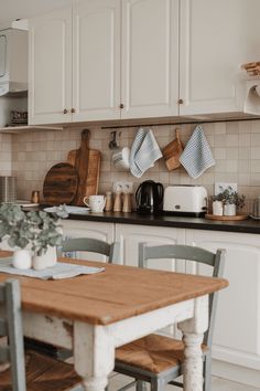 the kitchen is clean and ready to be used for cooking or baking, with dishes hanging on the wall