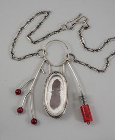 A talisman necklace with its central element being an elm tree seed set behind glass as a sort of biological specimen. One side resembles a branch with three red buds and the other side has a more primitive with its coral bead and silver discs. Elm Tree, Red Bud, Talisman Jewelry, Talisman Necklace, Unusual Jewelry, Coral Beads, Metal Jewelry, Pendant Necklaces, Handcrafted Jewelry