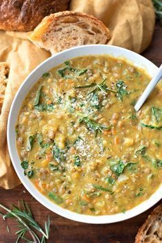 a bowl of soup with bread on the side