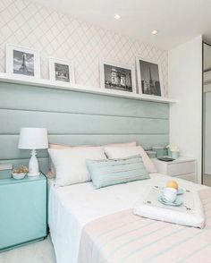 a bedroom with a bed, nightstands and pictures on the wall