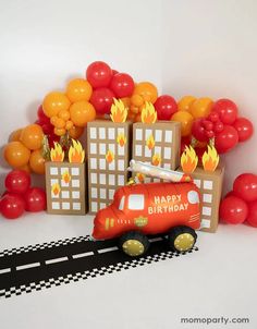 a birthday card with an orange truck and red balloons on the back ground in front of a white background