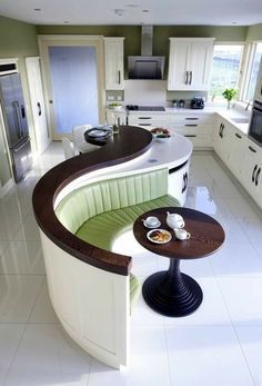 a kitchen with a curved counter and white tile flooring