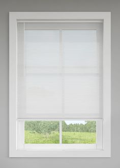 a window with white blinds in a room