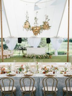 the tables are set up for an outdoor wedding