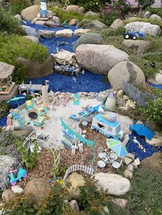 an aerial view of a garden with rocks, gravel and lawn furniture in the middle