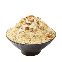 a black bowl filled with food on top of a white table