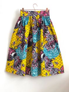 "Multicolour African high waist full gathered skirt. Perfect for casual outfits and special ocasions with pair of trainers or high heels. Skirt with elastic at the back of waist.  Two side pockets. Midi length skirt about 70 cm  + 5 cm waistband. Handmade in UK.  HOW TO CHOOSE A SIZE ?   Using a measuring tape, measure the smallest part of your waist.  SIZE CHART: (CM) XS - W: 66 CM S - W: 70 CM M - W: 74 CM  L - W: 78 CM  XL - W: 82 CM  CARE INSTRUCTIONS: Hand wash only, do not bleach, hang dry, do not tumble dry, press with a cool iron on the reverse side.  Please message me before purchasing so I can check availability. If you wish this skirt set in any other fabric, shorter or longer \"send message to seller\".  *Depends on computer/monitor settings colours might be different." Multicolor Midi Skirt Dress For Summer, Casual Multicolor Pleated Dress, Casual Pleated Multicolor Skirt, Multicolor Lined Skirt Dress For Summer, Multicolor Midi Dress For Spring, Casual Multicolor Lined Skirt, Casual Multicolor Relaxed Skirt, Multicolor Flowy Pleated Skirt Dress, Casual Yellow Tiered Skirt Dress