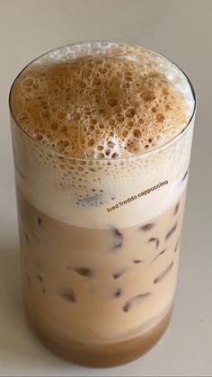 a tall glass filled with liquid on top of a table