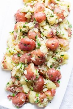 potato salad on a white platter with parsley