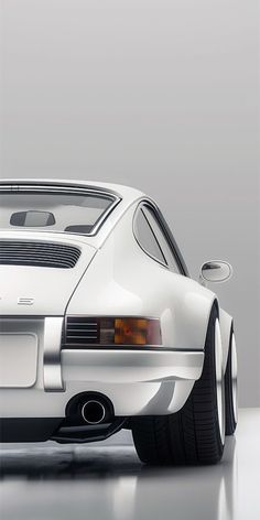 the rear end of a white sports car in a studio setting with its lights on