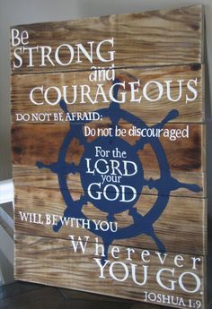 a wooden sign that says, be strong and courageous