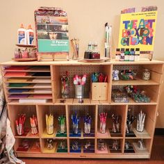 a wooden shelf filled with lots of school supplies