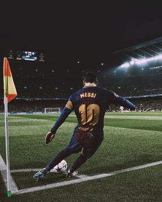 a soccer player is on the field with his foot in the air as he prepares to kick the ball