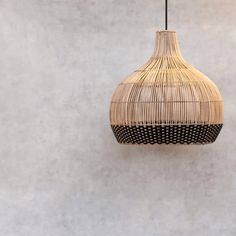 a hanging lamp made out of wicker on a wall