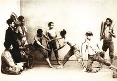 an old black and white photo of men dancing