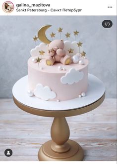 a pink cake with stars and a teddy bear on top