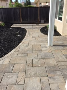 a brick walkway in front of a house