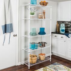 a white shelving unit in a kitchen