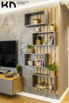 a living room filled with furniture and a flat screen tv on top of a wooden shelf