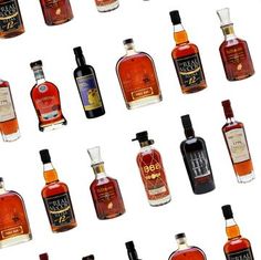 many different types of alcohol bottles on a white background