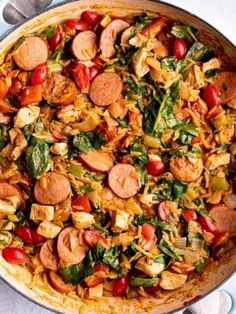 a skillet filled with sausage and vegetables