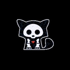 a black and white cat with a red heart on its chest, sitting in the dark