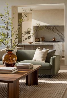 a living room filled with furniture and a large vase on top of a coffee table