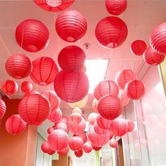 many red paper lanterns are hanging from the ceiling